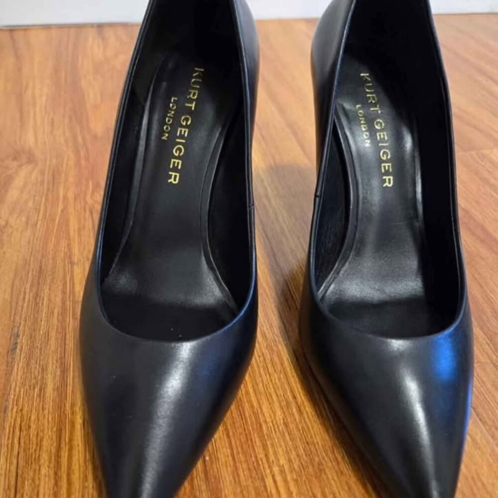 This is a pair of black high heels from the KURT GEIGER LONDON brand.